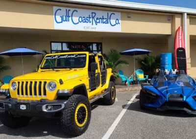 gulf coast rental company store front with yellow jeep and blue slingshot