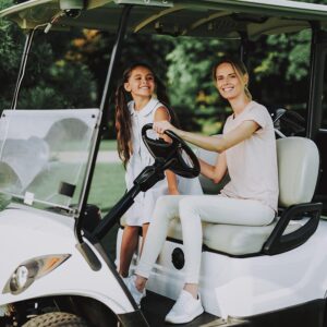 mother and daughter riding 4 person golf cart